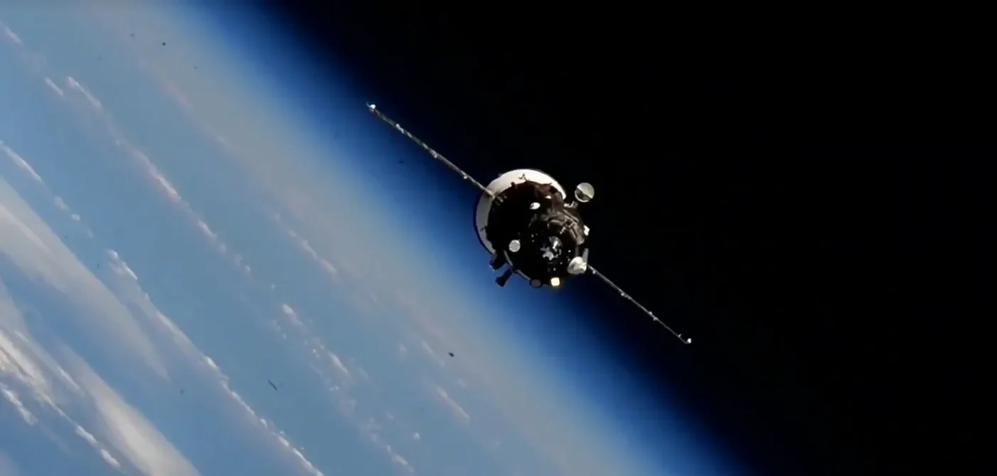Progress 94 cargo spacecraft approaching the International Space Station with Earth and the dark sky behind it